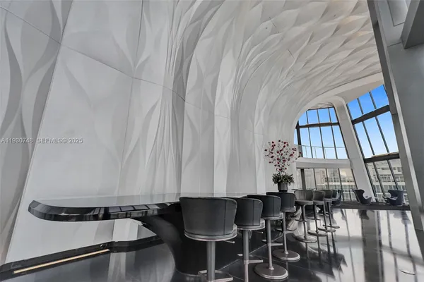 a living room with furniture and a projector screen