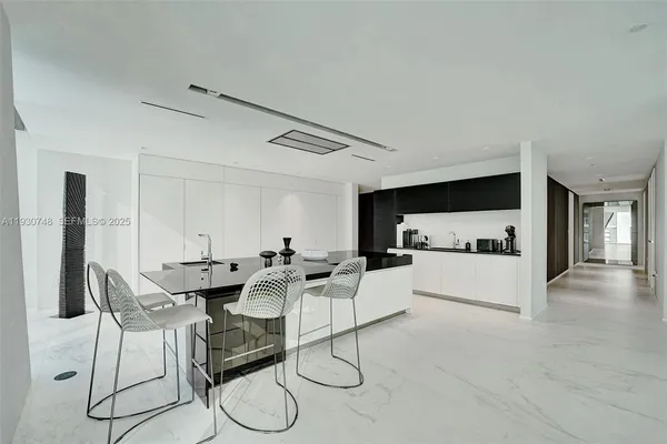 a living room with furniture and kitchen view