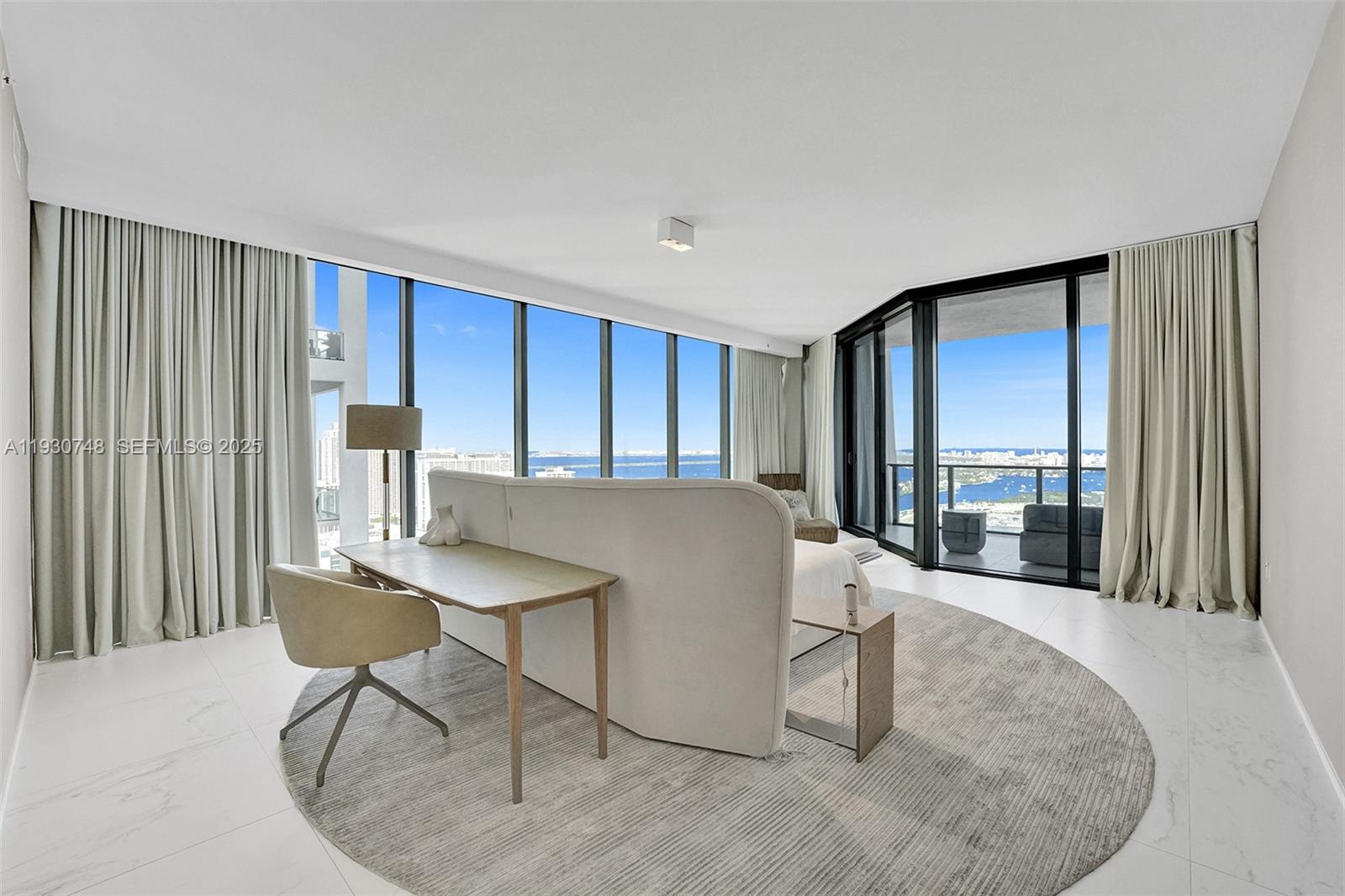 1000 Biscayne Boulevard, Unit 3902 Miami, FL 33132 - Photo 10 of 51 a living room with furniture a large window and chair