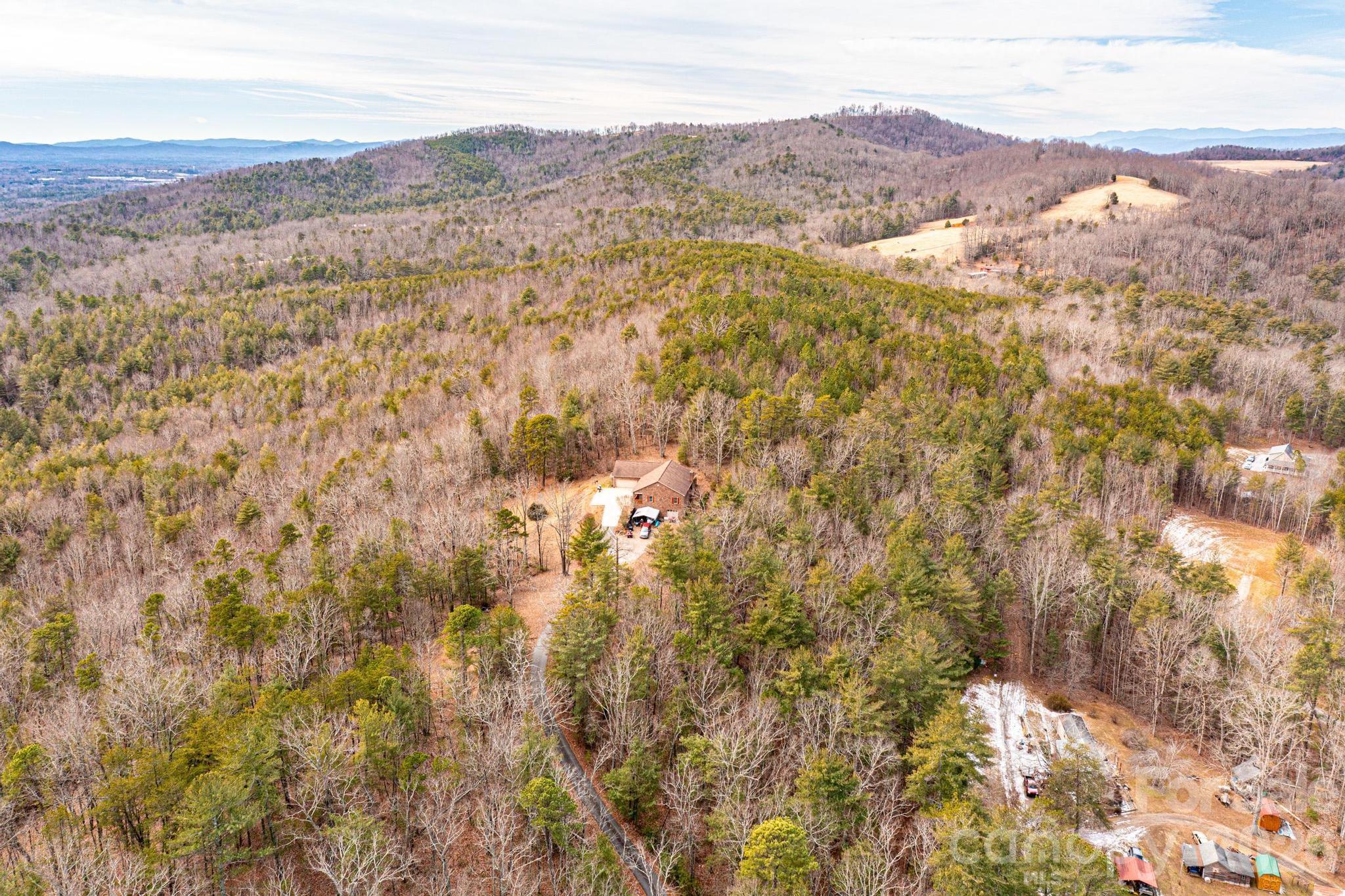 3941 Fox Winkler Road Lenoir, NC 28645 - Photo 18 of 20 a view of a dry yard with mountains in the background