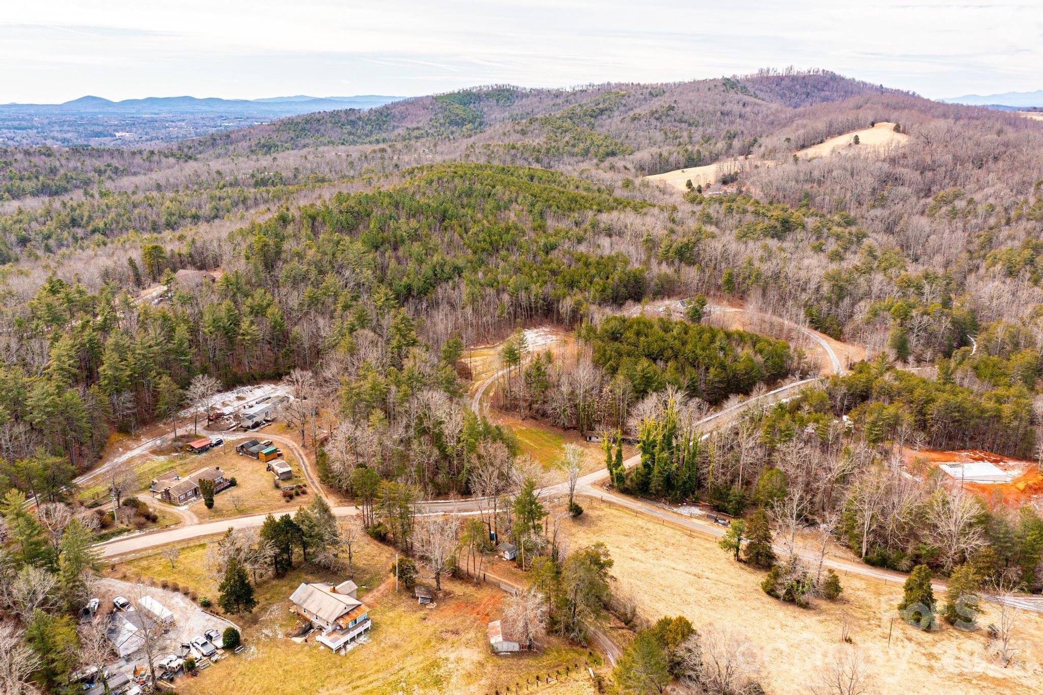 3941 Fox Winkler Road Lenoir, NC 28645 - Photo 19 of 20 a view of a lush green hillside and houses
