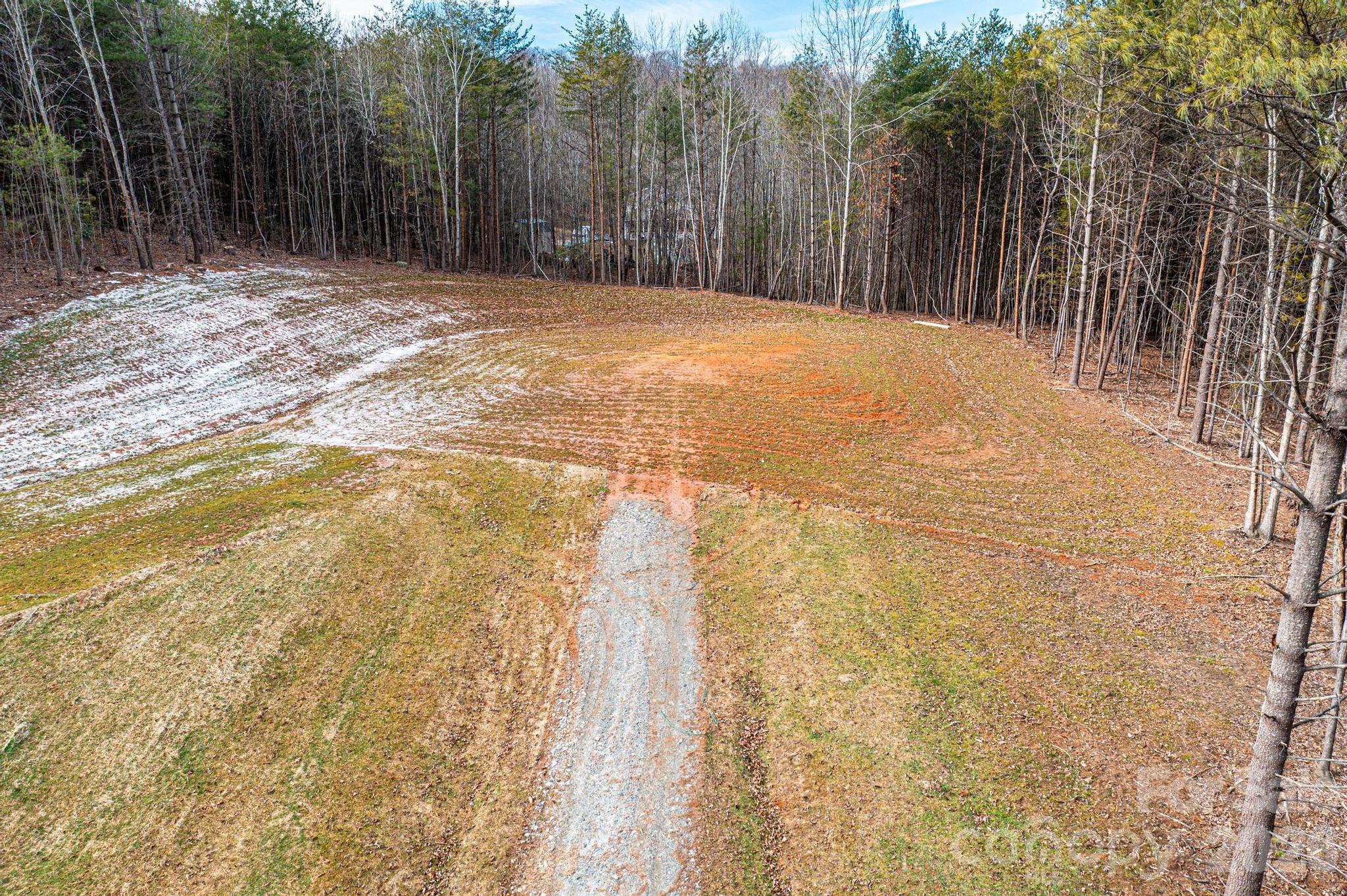 3941 Fox Winkler Road Lenoir, NC 28645 - Photo 3 of 20 a backyard of a house with trees in the background