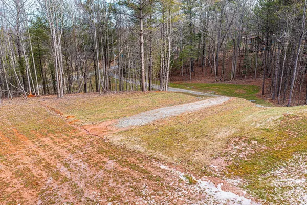 a view of a yard with basketball court