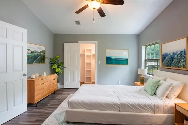 a bedroom with a bed and a chandelier