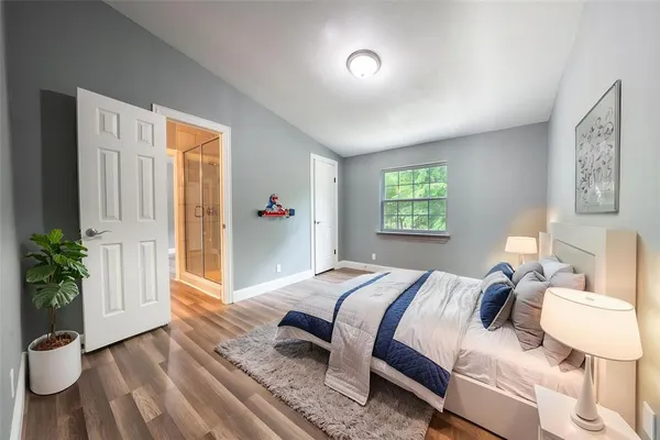 a bedroom with a bed and a window