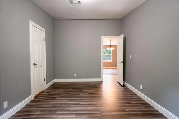 a view of a hallway with wooden floor