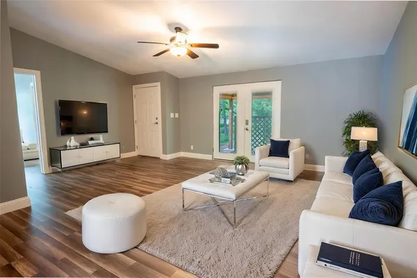 a living room with furniture and a flat screen tv