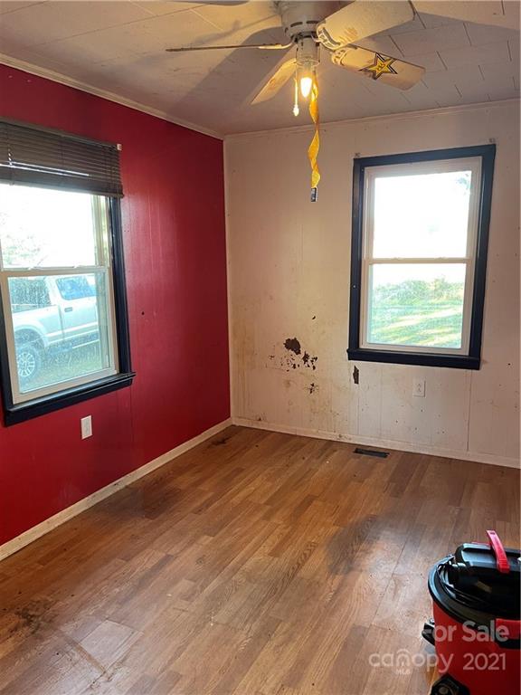 1354 Goble Road Hiddenite, NC 28636 - Photo 9 of 11 a view of an empty room with window and wooden floor