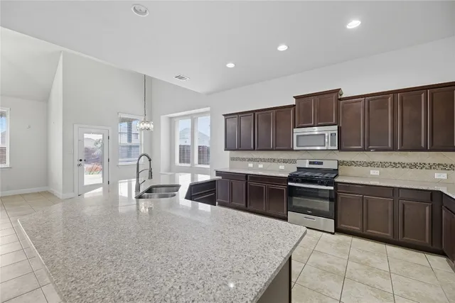 a kitchen with a sink and cabinets