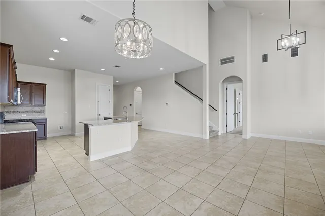 a kitchen with stainless steel appliances granite countertop a sink stove and cabinets