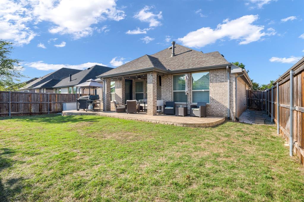 1501 Snowdrop Drive Prosper, TX 75078 - Photo 9 of 27 a view of a house with a backyard porch and sitting area