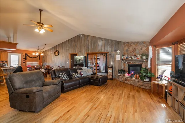 a living room with fireplace furniture and a wooden floor