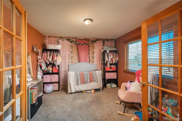 a bedroom with bunk bed and a window