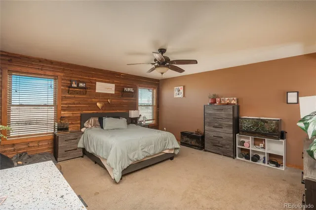 a bedroom with a bed cabinets and a window