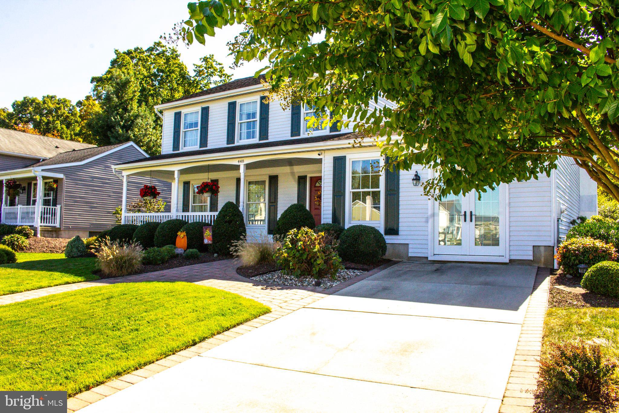 a front view of a house with garden and porch