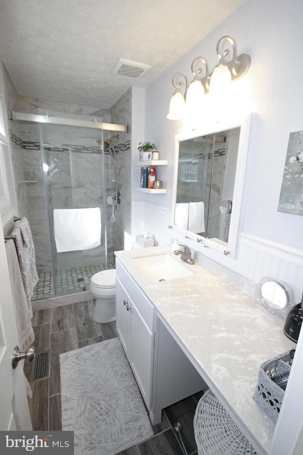 448 Inverness Road Williamstown, NJ 08094 - Photo 12 of 32 a bathroom with a granite countertop sink a toilet a mirror and bathtub