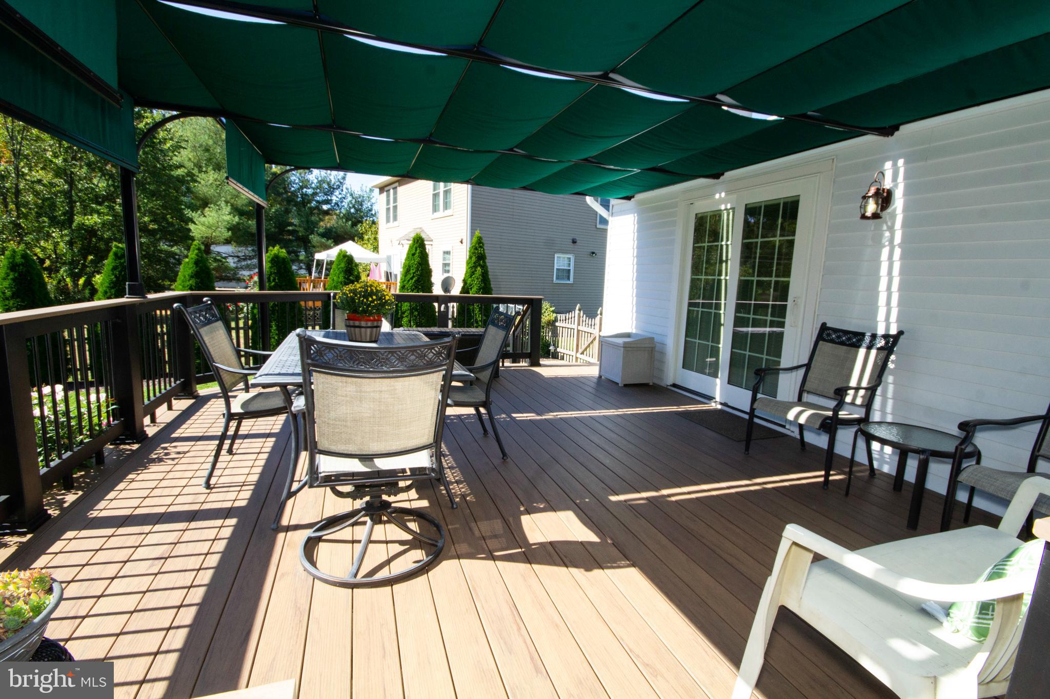 448 Inverness Road Williamstown, NJ 08094 - Photo 26 of 32 a view of a patio with table and chairs potted plants with wooden floor