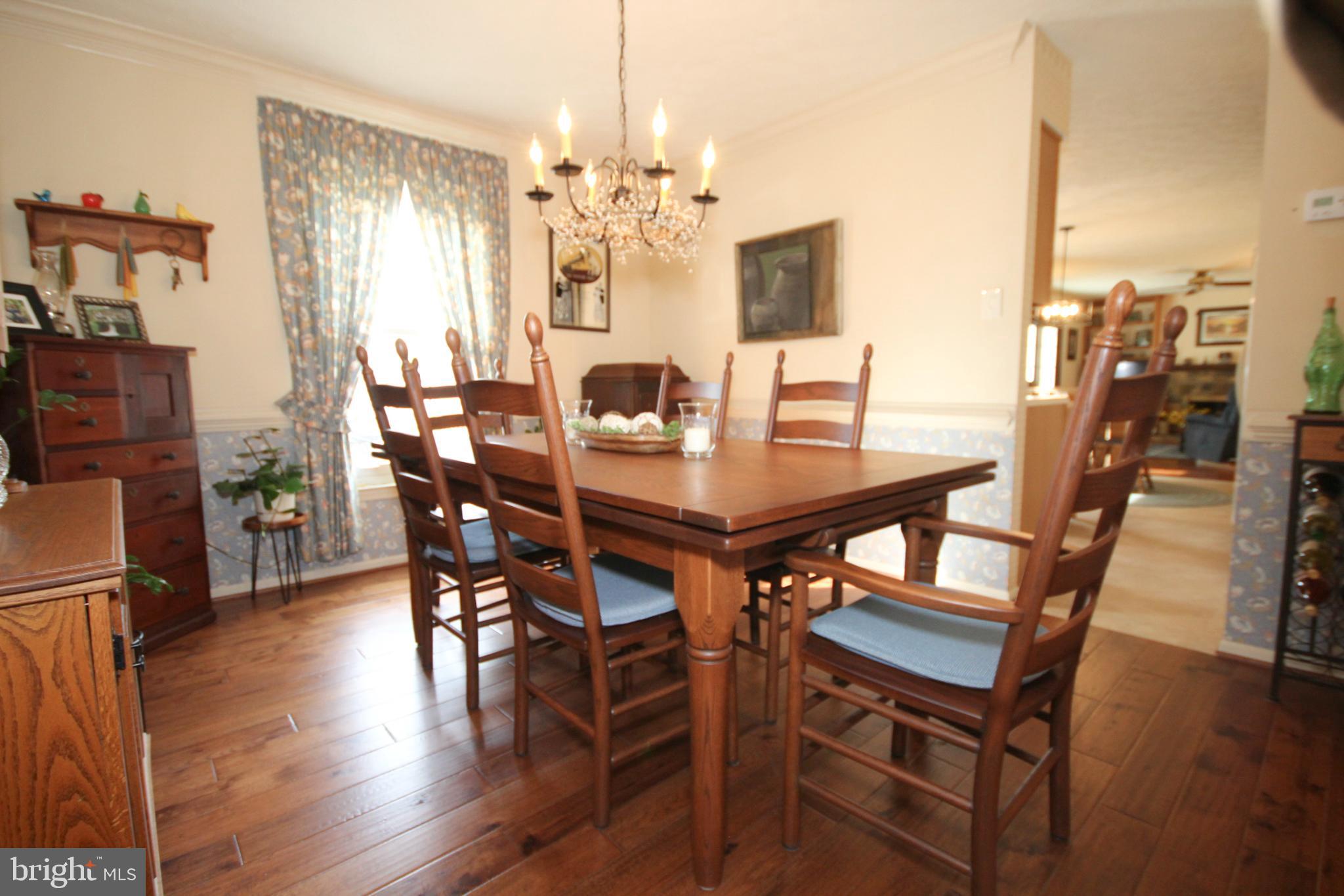 448 Inverness Road Williamstown, NJ 08094 - Photo 3 of 32 a view of a dining room with furniture a chandelier and wooden floor