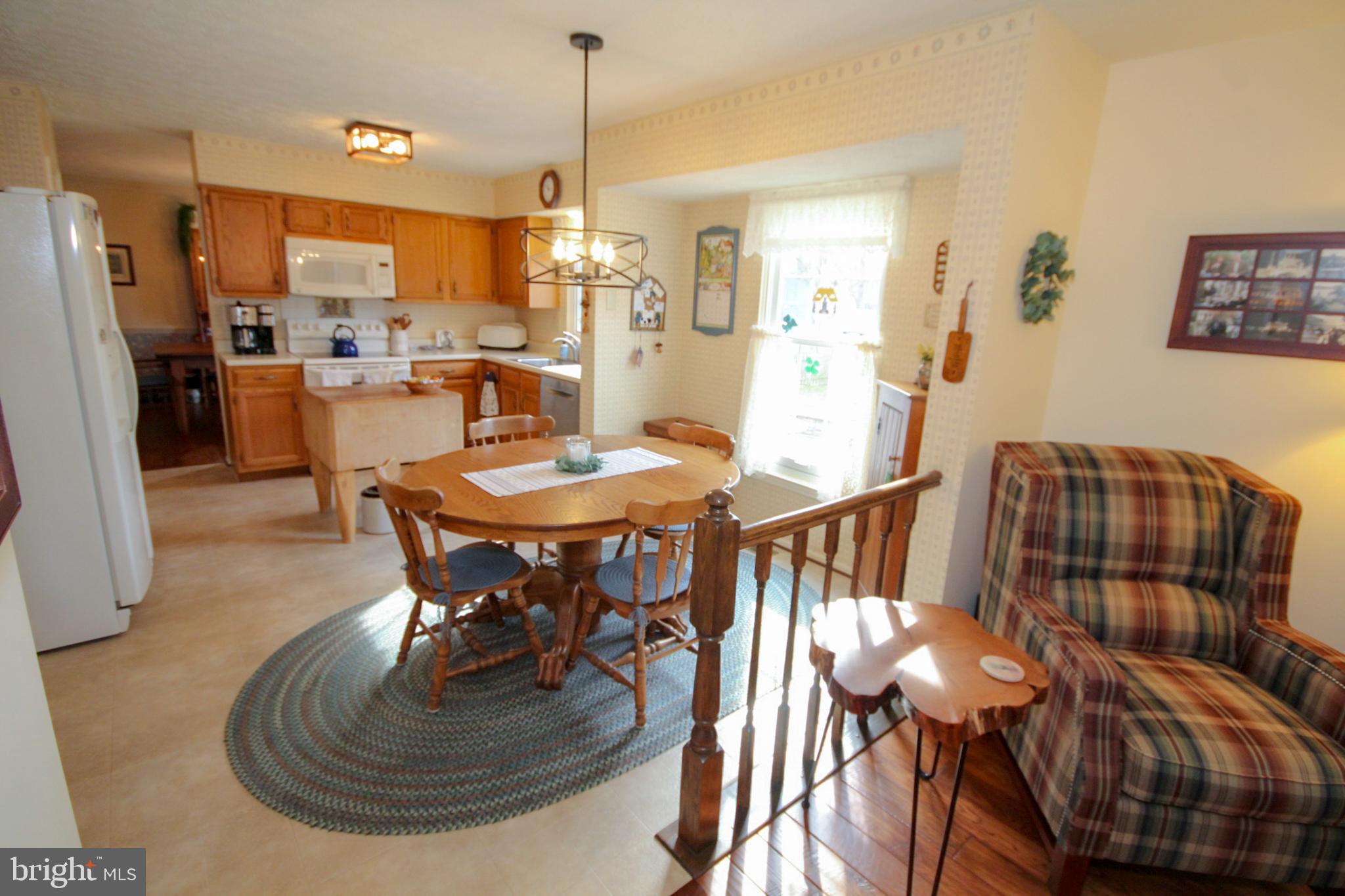 448 Inverness Road Williamstown, NJ 08094 - Photo 4 of 32 a dining room with furniture a kitchen and chandelier