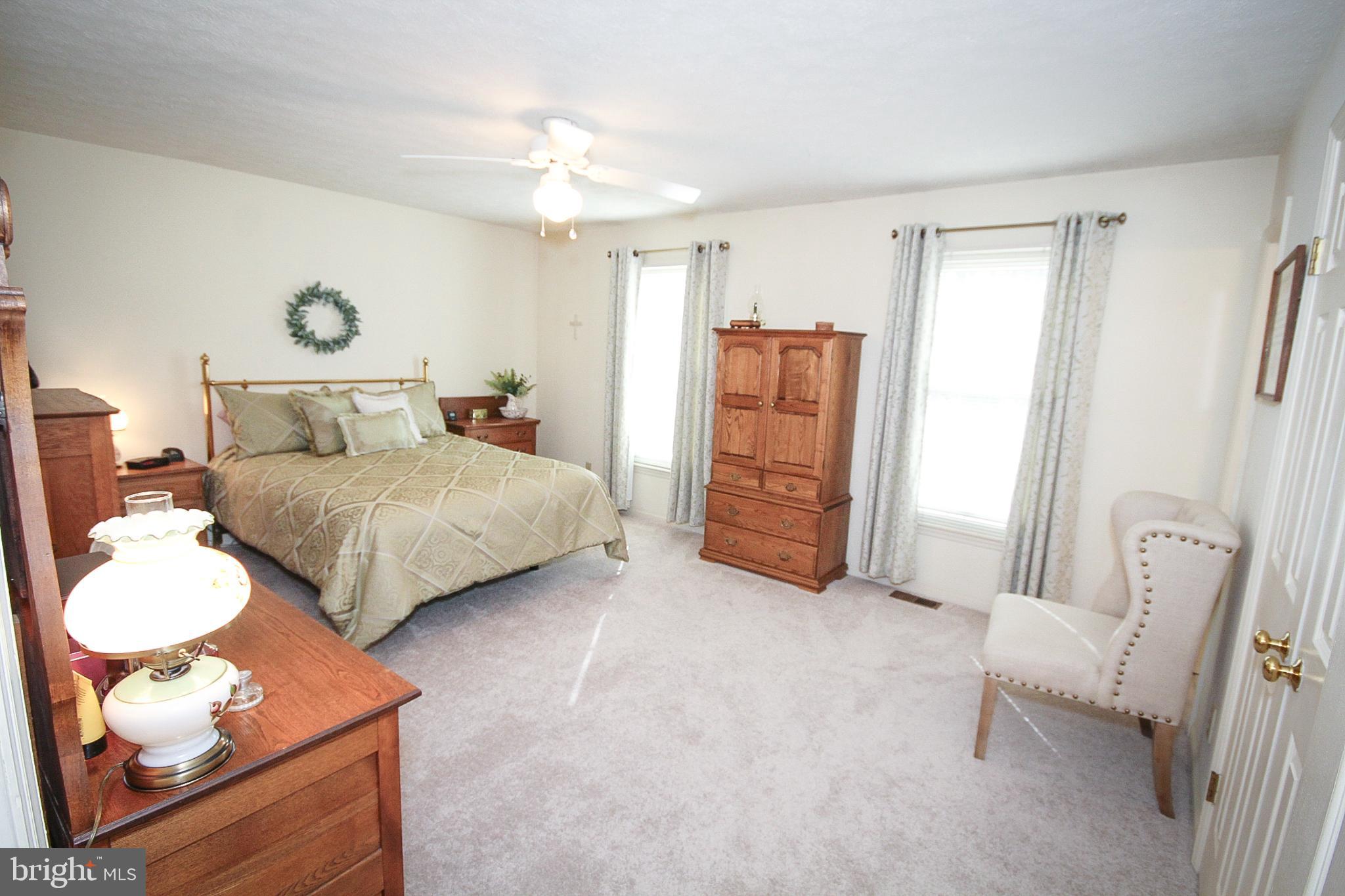 448 Inverness Road Williamstown, NJ 08094 - Photo 10 of 32 a bedroom with a bed and a chandelier