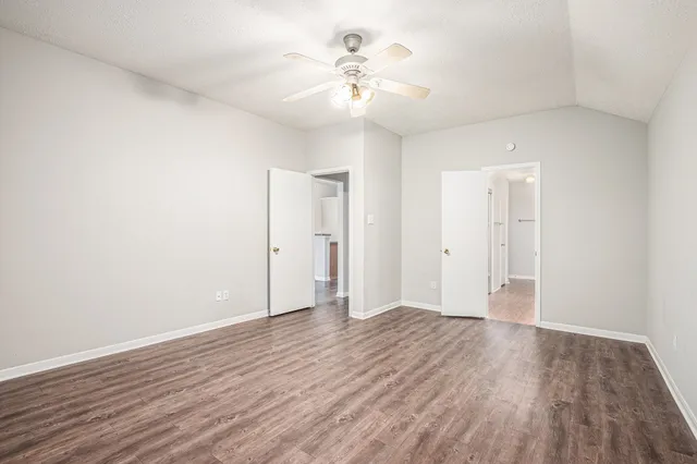 a view of an empty room with wooden floor