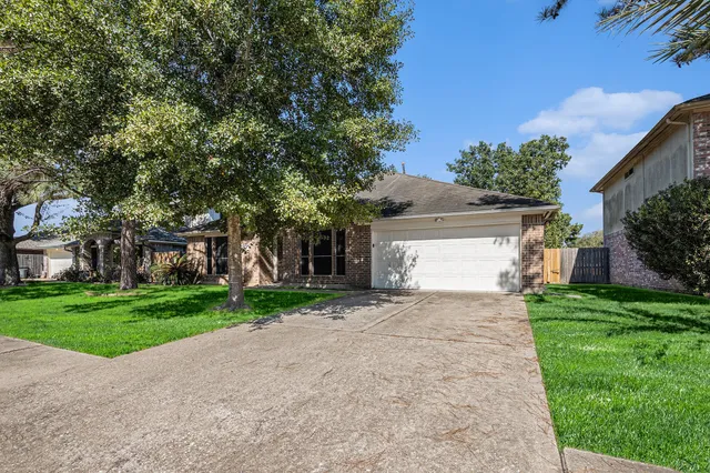 a view of a house with a yard and tree s