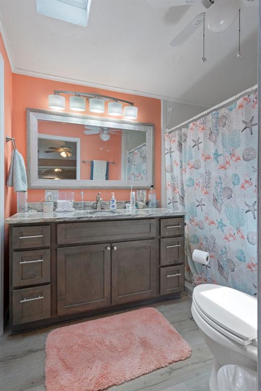 16203 Brookridge Boulevard Brooksville, FL 34613 - Photo 18 of 44 a bathroom with a sink a toilet and vanity