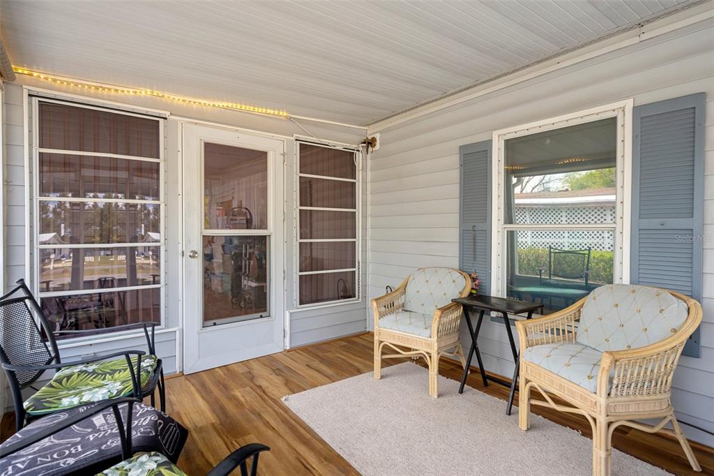 16203 Brookridge Boulevard Brooksville, FL 34613 - Photo 26 of 44 a balcony with furniture and a potted plant
