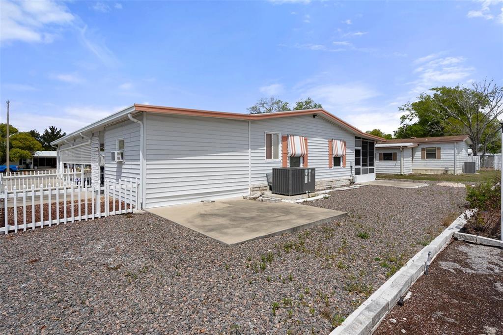 16203 Brookridge Boulevard Brooksville, FL 34613 - Photo 28 of 44 a front view of a house with a yard