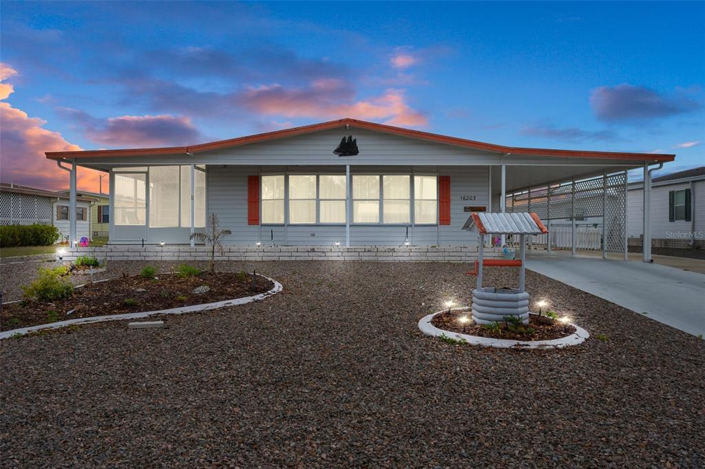 16203 Brookridge Boulevard Brooksville, FL 34613 - Photo 43 of 44 a front view of a house with a yard