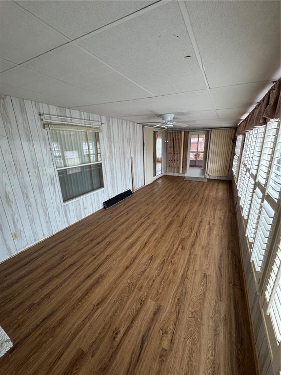 16203 Brookridge Boulevard Brooksville, FL 34613 - Photo 9 of 44 a view of an empty room with wooden floor and a window