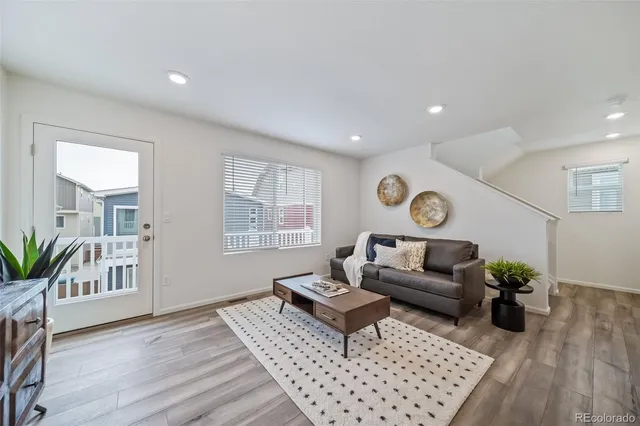 a living room with furniture and wooden floor