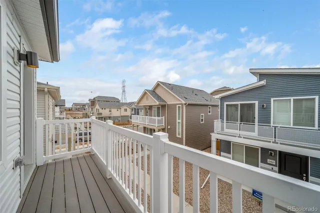 a view of a house with wooden deck and city view