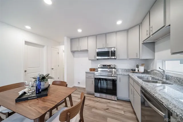 a kitchen with a stove a sink and a refrigerator