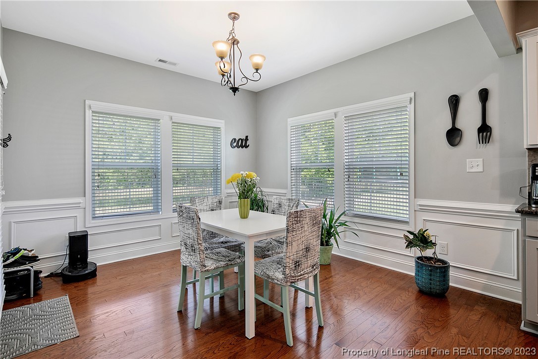 164 Valley Stream Road Spring Lake, NC 28390 - Photo 14 of 49 a view of a dining room with furniture window and wooden floor