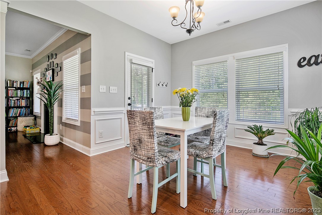 164 Valley Stream Road Spring Lake, NC 28390 - Photo 16 of 49 a view of a dining room with furniture and wooden floor