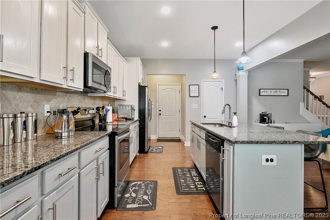 164 Valley Stream Road Spring Lake, NC 28390 - Photo 18 of 49 a kitchen with granite countertop stainless steel appliances a sink a stove and cabinets