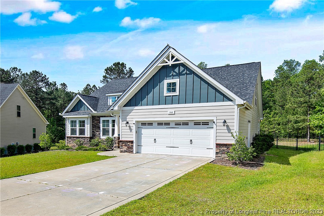 164 Valley Stream Road Spring Lake, NC 28390 - Photo 2 of 49 a front view of a house with a yard and garage