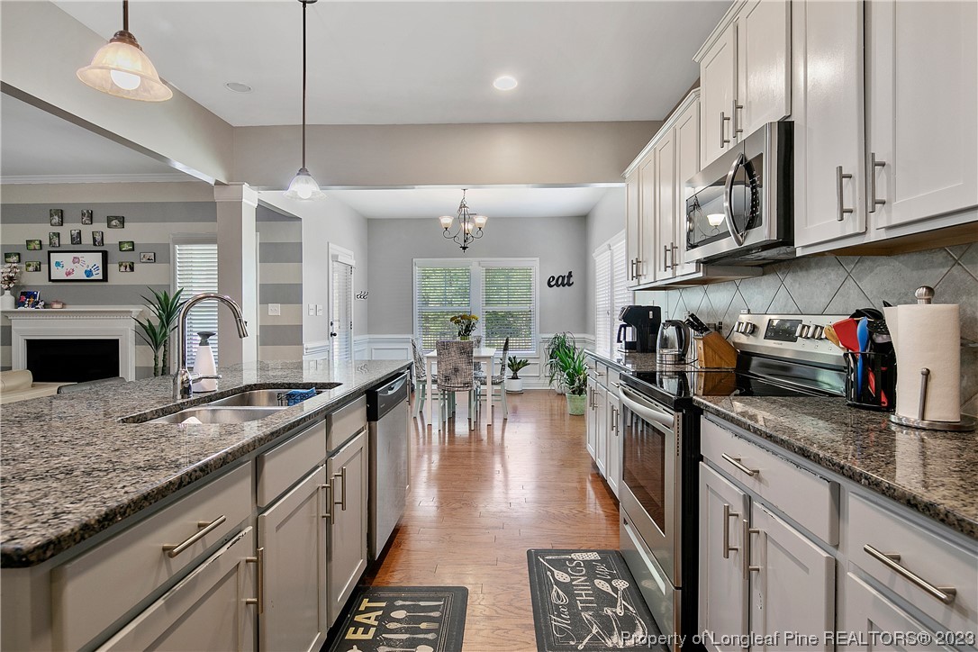 164 Valley Stream Road Spring Lake, NC 28390 - Photo 21 of 49 a kitchen with granite countertop lots of counter top space appliances and cabinets