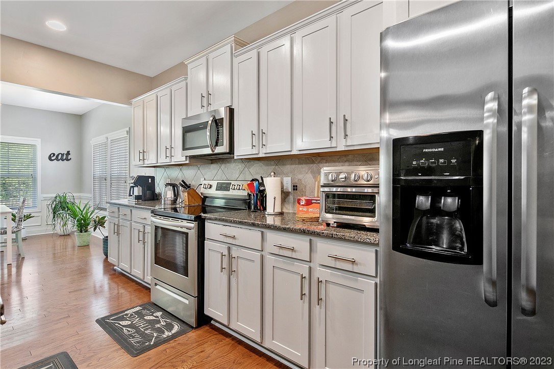 164 Valley Stream Road Spring Lake, NC 28390 - Photo 22 of 49 a kitchen with stainless steel appliances granite countertop a refrigerator sink and stove