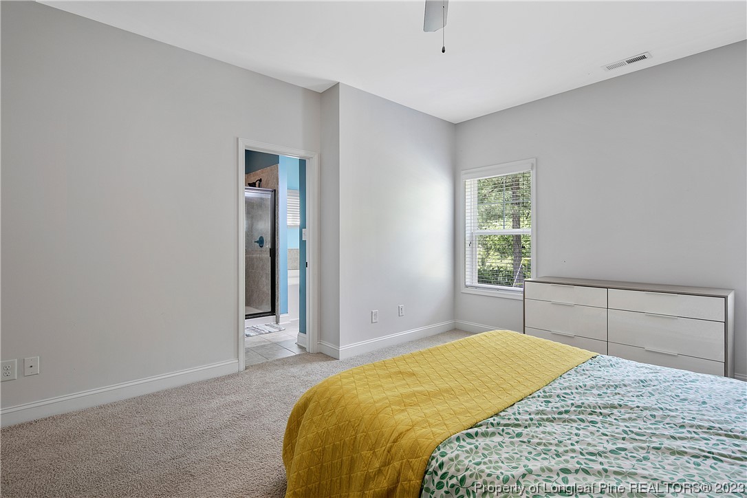 164 Valley Stream Road Spring Lake, NC 28390 - Photo 25 of 49 a bedroom with a bed and a window