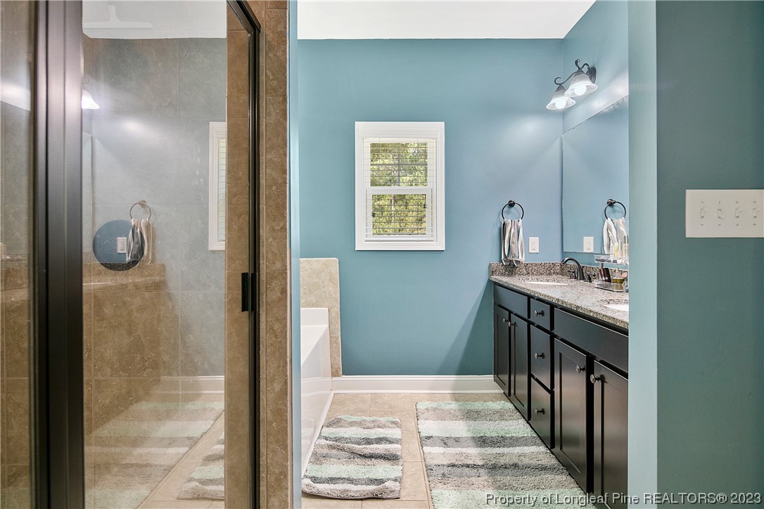 164 Valley Stream Road Spring Lake, NC 28390 - Photo 26 of 49 a bathroom with a sink and a mirror