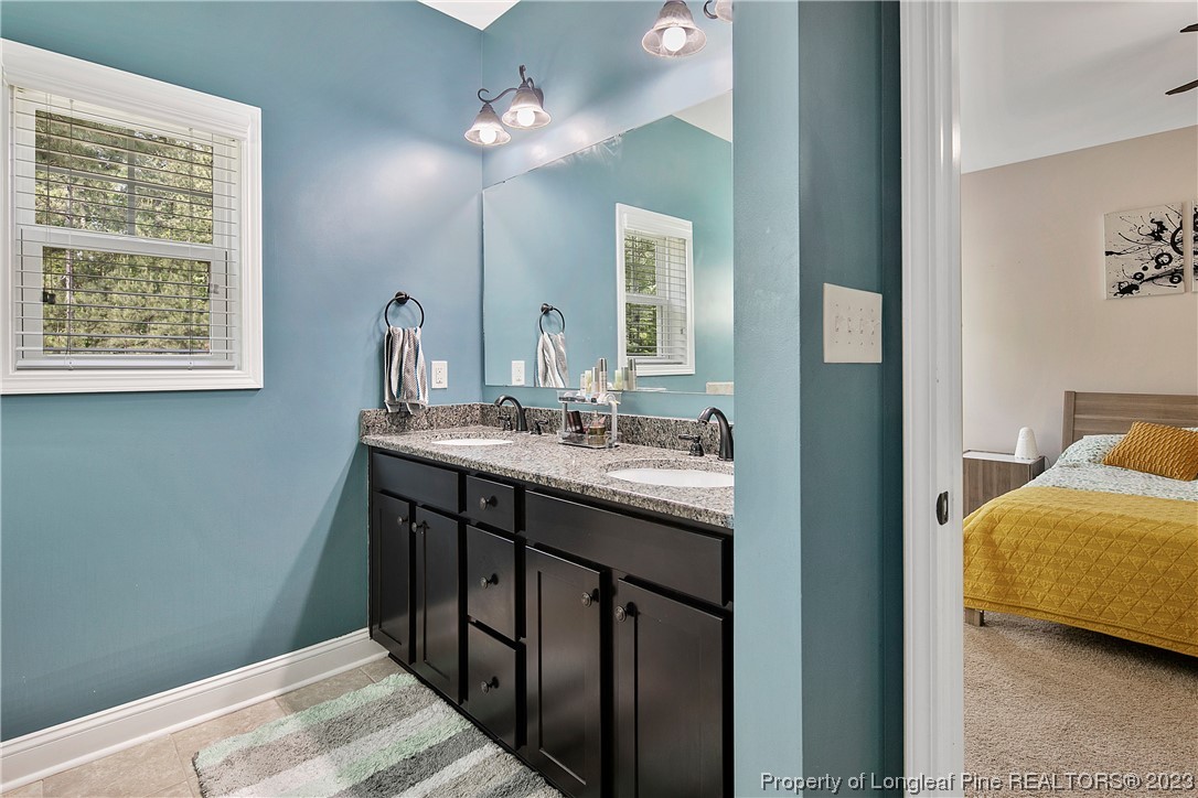 164 Valley Stream Road Spring Lake, NC 28390 - Photo 27 of 49 a en suite bathroom with a double vanity sink and a mirror