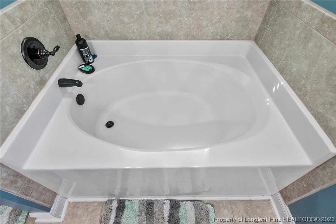 164 Valley Stream Road Spring Lake, NC 28390 - Photo 29 of 49 a bathroom with a tub