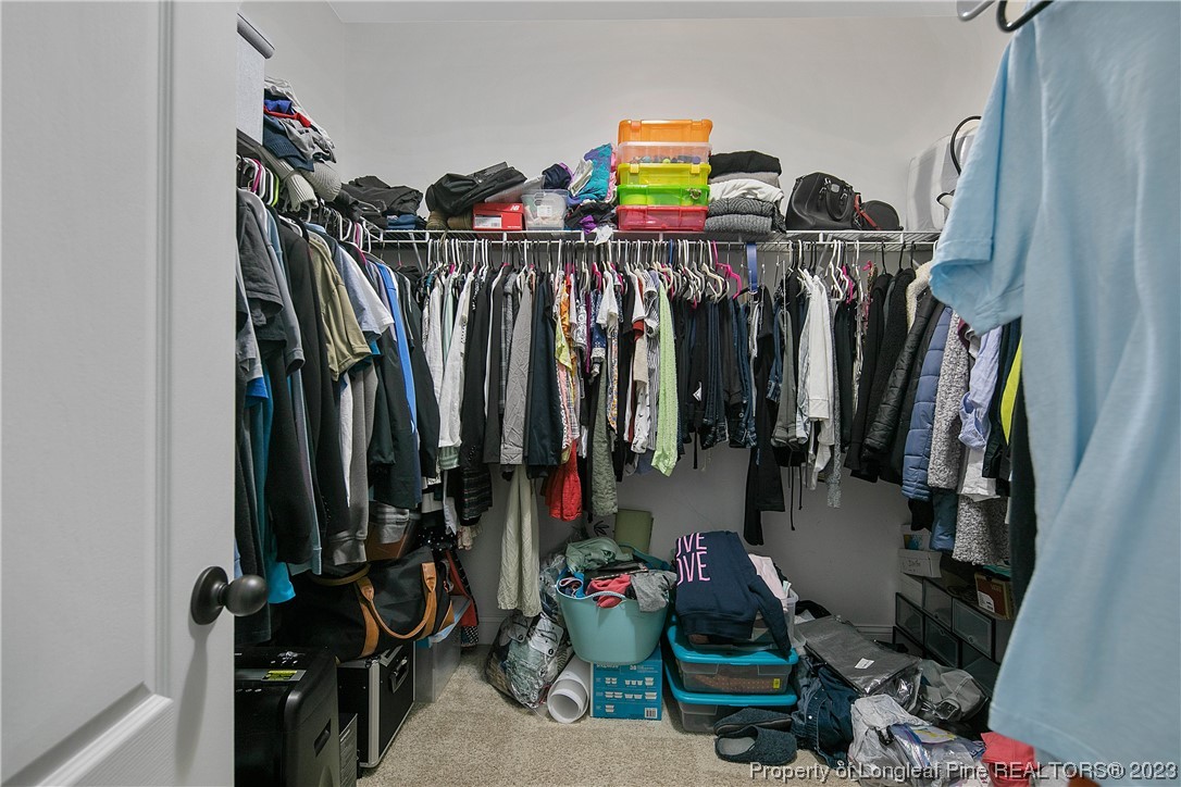 164 Valley Stream Road Spring Lake, NC 28390 - Photo 30 of 49 a view of walk in closet with clothes