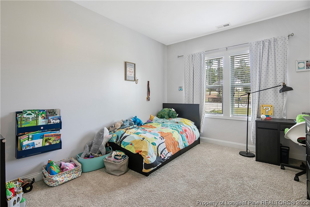 164 Valley Stream Road Spring Lake, NC 28390 - Photo 31 of 49 a bedroom with a bed and a window