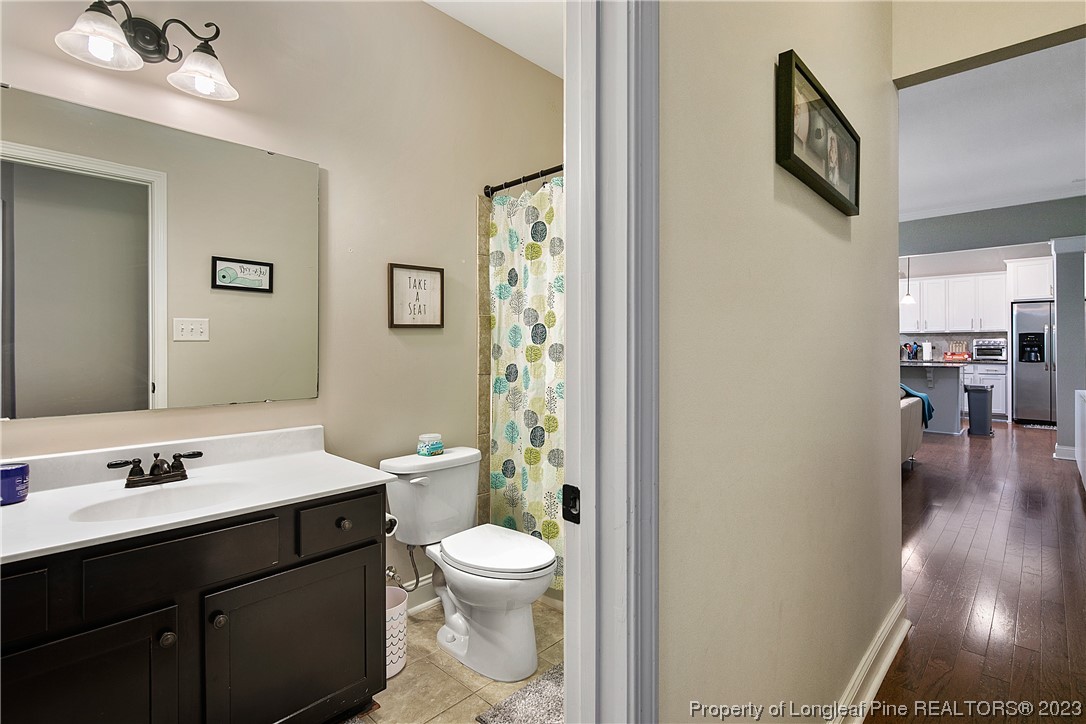 164 Valley Stream Road Spring Lake, NC 28390 - Photo 34 of 49 a bathroom with a sink a toilet and shower