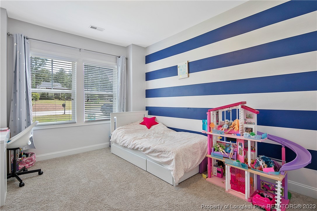164 Valley Stream Road Spring Lake, NC 28390 - Photo 37 of 49 a living room with baby crib furniture and a book shelf