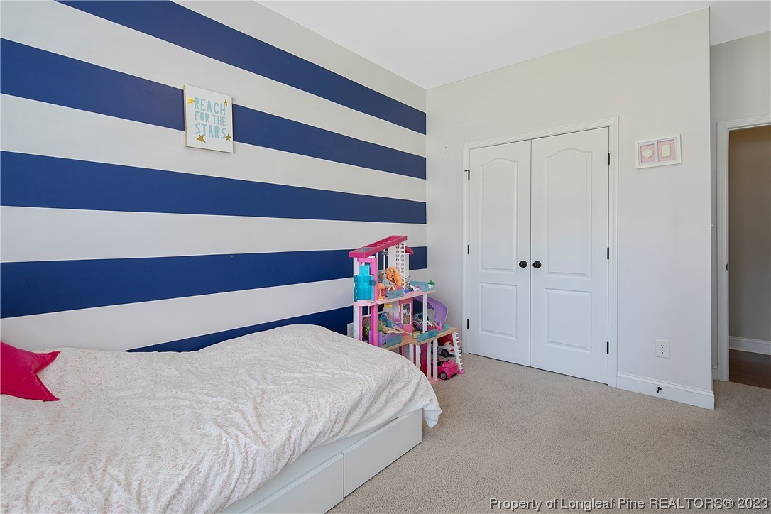 164 Valley Stream Road Spring Lake, NC 28390 - Photo 38 of 49 a bedroom with a bed and a closet