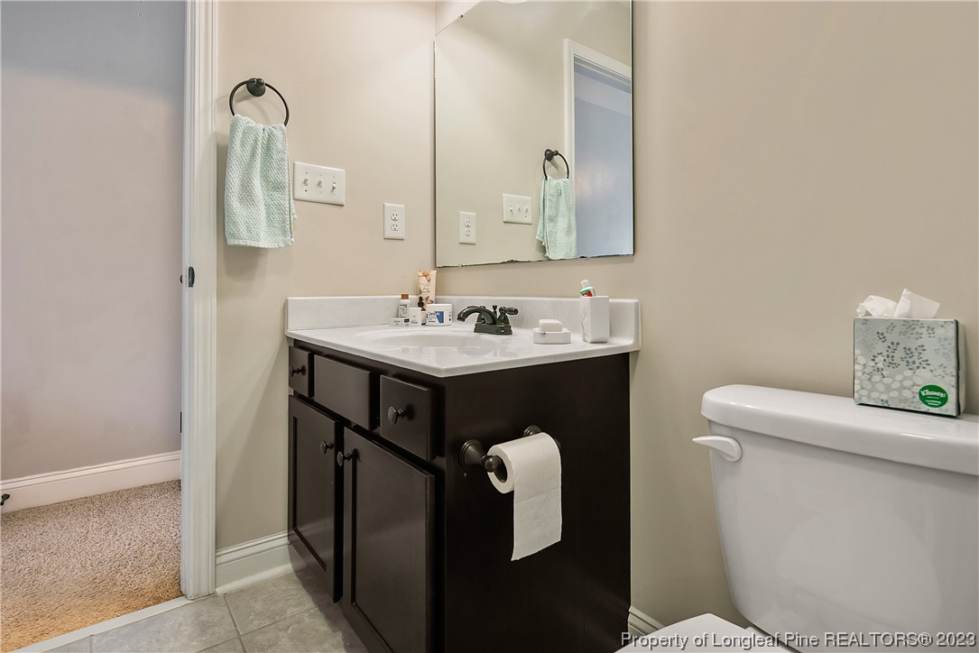 164 Valley Stream Road Spring Lake, NC 28390 - Photo 43 of 49 a bathroom with a sink toilet and mirror